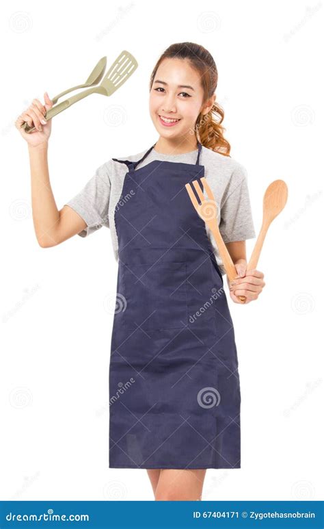 Asian Woman Wearing Apron And Showing Cooking Tools Stock Image