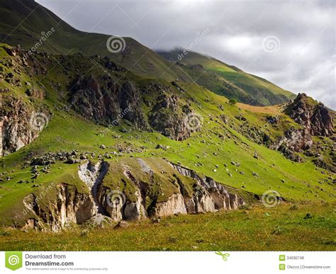 Green Hillside Under A Cloudy Sky Stock Photo Image Of Climate Grass