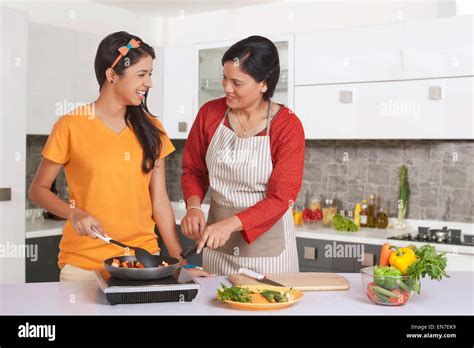 Mother Teaching Daughter To Cook Stock Photo Alamy
