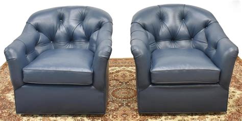 For the shopper who is looking for a style more. (2) BLUE LEATHER UPHOLSTERED SWIVEL LOUNGE CHAIRS