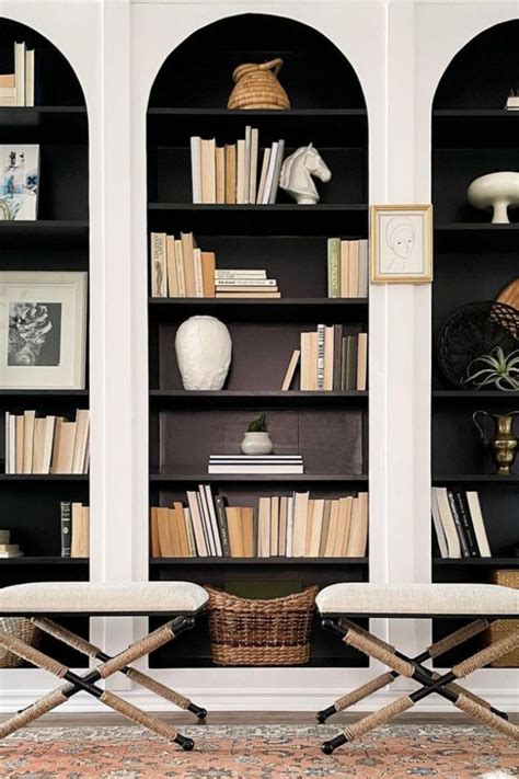 Two Chairs Sitting In Front Of A Book Shelf Filled With Books