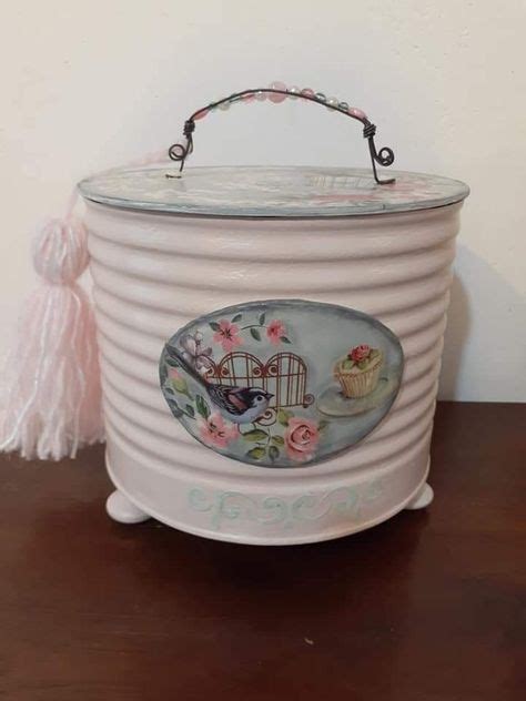 An Old Fashioned Ice Bucket With Flowers And Birds Painted On The Side