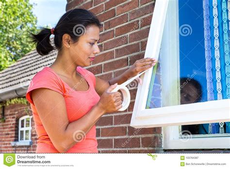 Woman Sticking Adhesive Tape On Window Glass Stock Image Image Of