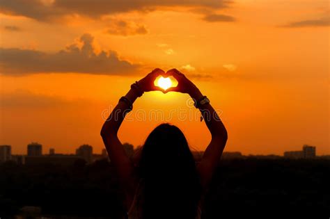 Sunset Of Girl Catching Sun In Heart Stock Photo Image