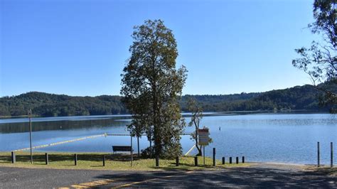 A boat launch ramp is nearby. View of lake with boat ramp and swimming area, at the ...