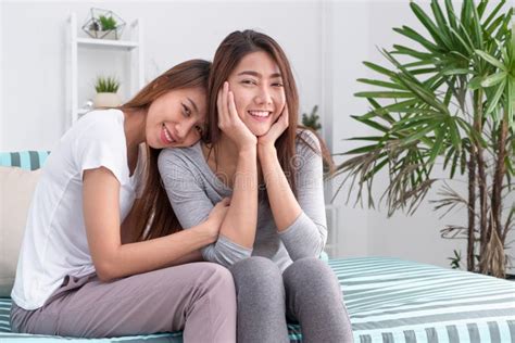 Two Asia Woman Hug Each Another And Sitting On Sofa In Living Room At Home Relax Time Lesbian