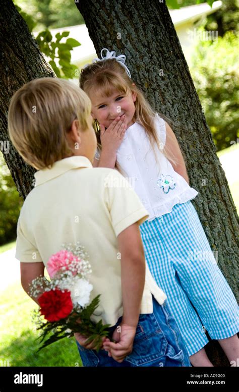 Boy Giving Girl Flowers Stock Photo 4271103 Alamy