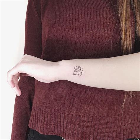A Woman With A Small Tattoo On Her Arm