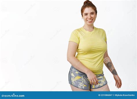 Portrait Of Smiling Chubby Redhead Girl Workout In Gym Standing In Fitness Clothes Standing