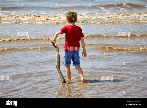 Boy Play In The Sea At Coastal Area Waterloo Crosby Beach Liverpool