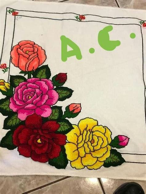 A White Towel With Flowers On It And The Number Four In Front Of It