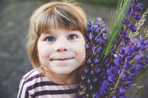 Cute Adorable Little Toddler Girl With Huge Bouquet Of Blossoming