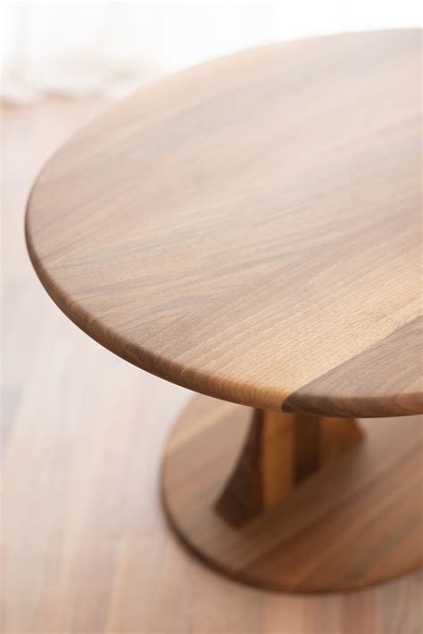 A glass coffee table makes for an elegant, subtle addition to the room, while a coffee table with storage is perfect for creating space for a striking centerpiece. Ellipse solid wood coffee table by Charlie Pommier
