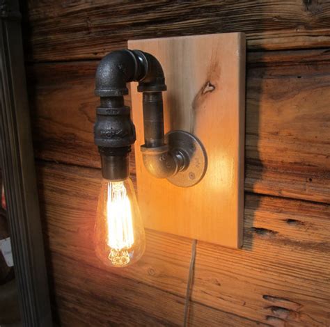 Pipe onto the wood back plate, put the copper straps (2) on the pipe as pictured. black pipe wall sconce with edision bulb