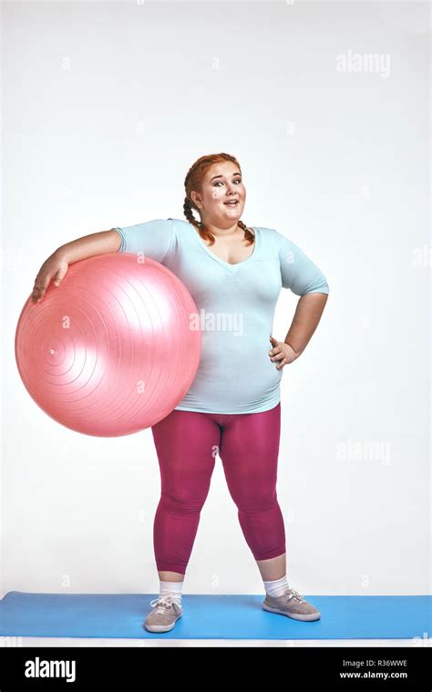 Funny Picture Of Amusing Red Haired Chubby Woman Which Is Holding A