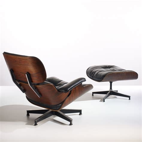I believe this is the cherry version which is no longer in production. 134: CHARLES AND RAY EAMES, 670 lounge chair and 671 ottoman
