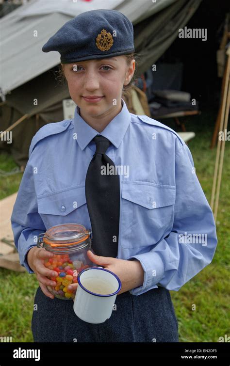 Young Girl In Raf Uniform With Tin Mug And Kilner Jar With Sweets Stock