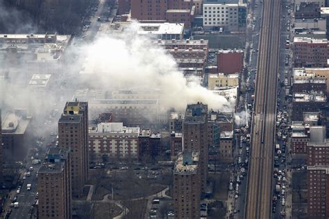 Smoke Billows From The Site Of A Building Collapse As Debris Litters