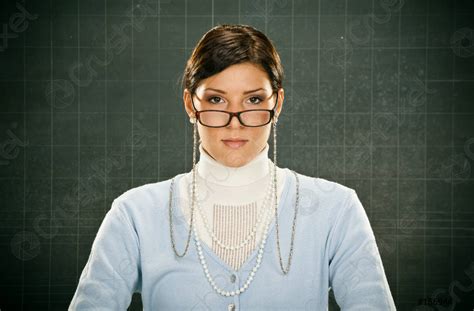 Beautiful Serious Young Teacher With Glasses And Blackbouard Stock