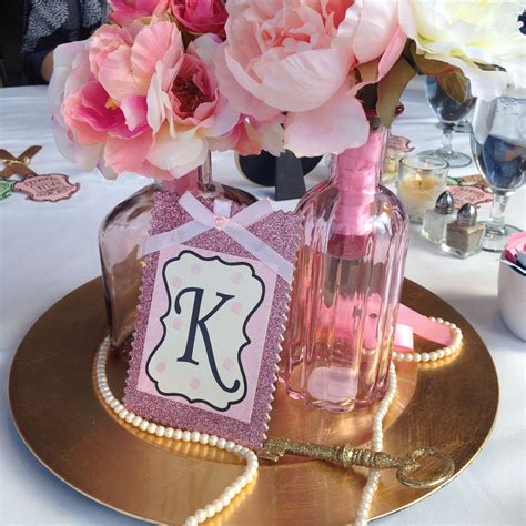 This umbrella centerpiece can be used for a variety of party celebrations. DIY Pink and Gold Centerpieces | 1st birthday centerpieces, Birthday centerpieces, Pink and gold