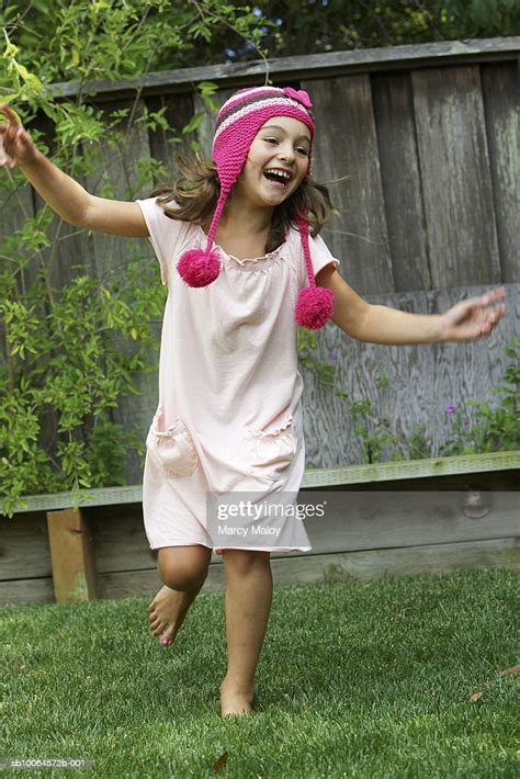 Girl In Woolen Hat Dancing In Yard High Res Stock Photo Getty Images