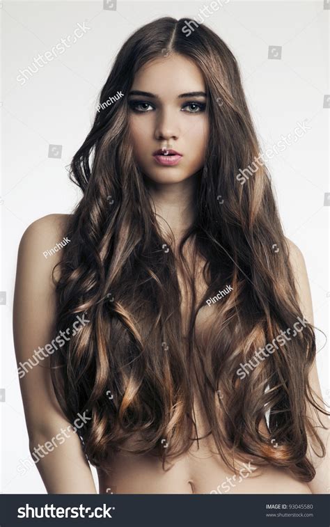 Beautiful Woman With Perfect Skin And Long Curly Hair On A White
