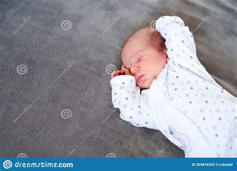 Baby Newborn Sleeping Covered On Gray Woolen Blanket Stock Photo
