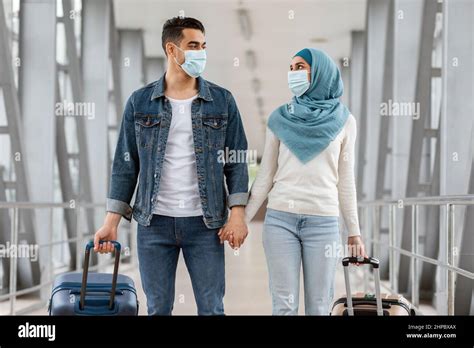 Happy Muslim Couple Wearing Protective Medical Masks Walking With