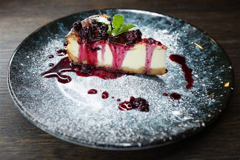 Delicious Creamy Dessert Cheesecake With Cherry Jam A Leaf Of Mint