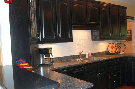 The first was a house that we bought that already had matte black ceramic tile and oak cabinets which i painted. distressed black cabinets with black granite countertops ...
