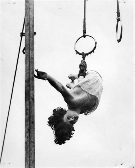 A Woman Is Doing Aerial Tricks On A Pole