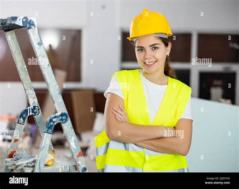 Confident Smiling Female Civil Engineer With Crossed Arms At