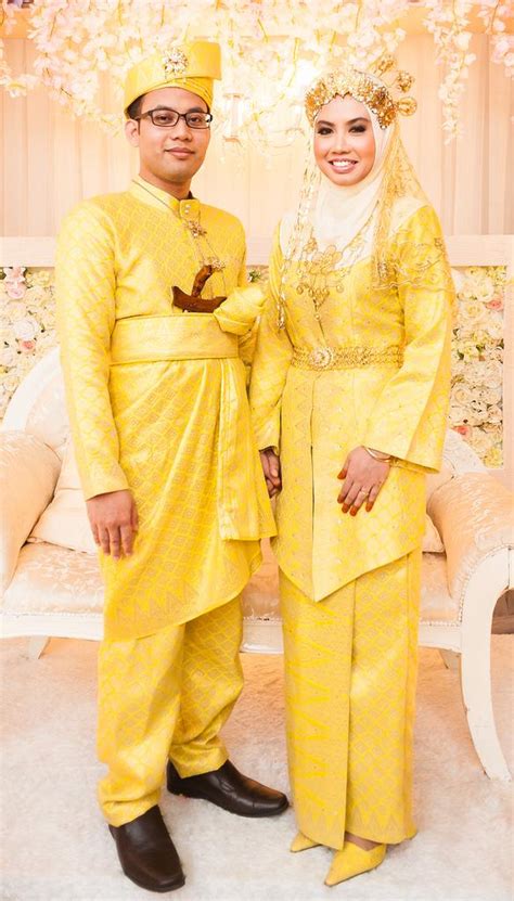 malay groom and bride wearing yellow coloured traditional songket dress 1957077 weddbook