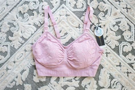 A Pink Bra That Is Laying On The Ground Next To A Rug With A Tag