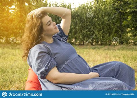 Beautiful Pregnant Tenderness Mother Girl In Nature Relaxing Sunlight