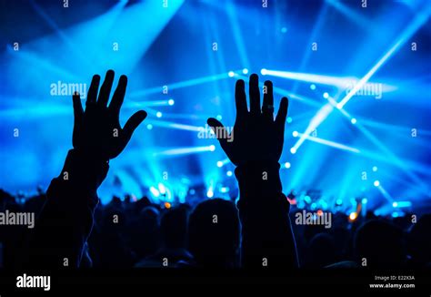 Music Concert Silhouette Of Mans Hands Up Crowd Of People Active