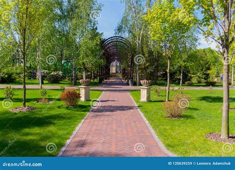 Path In A Beautiful Green Park To A Wooden Arched Alley With Hinged