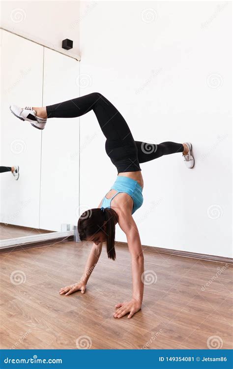 Young Fit Woman Doing Handstand Exercise In Gym Stock Image Image Of