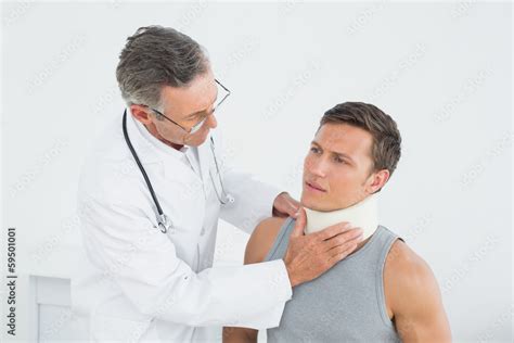 Doctor Examining A Patients Neck In Office Stock Photo Adobe Stock