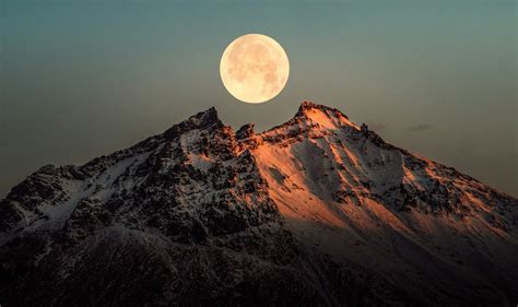 A Full Moon Rising Over A Snowy Mountain Photo Free Nature Image On