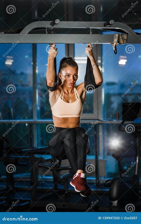 the perfect sport girl pulls up on the horizontal bar in the gym stock image image of workout