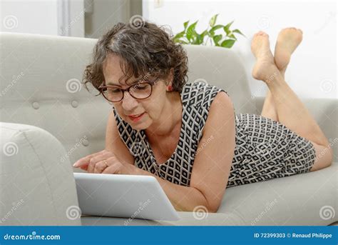 Beautiful Mature Woman With A Tablet On The Sofa Stock Image Image Of Adult People 72399303