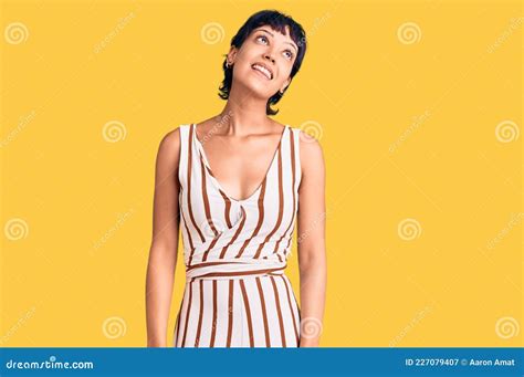 Young Brunette Woman With Short Hair Wearing Summer Outfit Looking Away