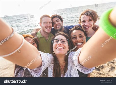Multiracial Group Of Friends Taking Selfie At Beach One Girl Is Asiatic Two Persons Are Black