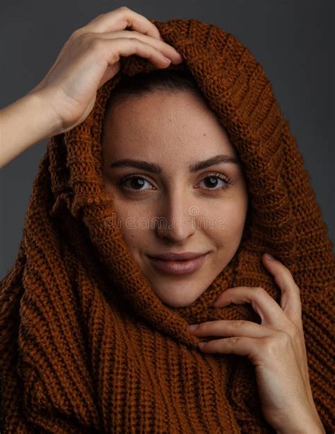 Cute Young Woman Undressing Pulling A Knitted Cardigan Or Sweater Over