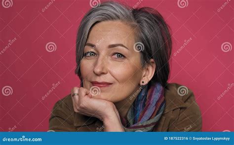 Sweet Mature Woman Charmingly Smiles Looking At Camera Dressed In Brown Corduroy Jacket With