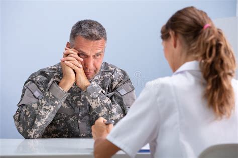 Female Doctor Discussing With Army Soldier Suffering From Ptsd Stock Image Image Of Depressed