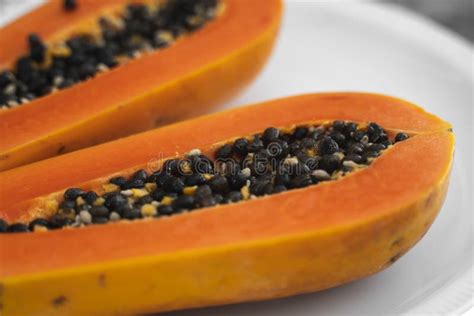 Half Cut Ripe Papaya With Seed On A White Plate Slices Of Sweet Papaya