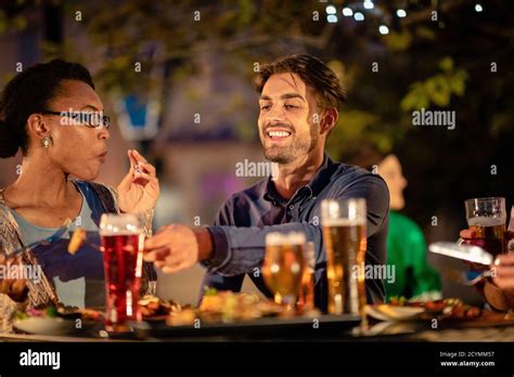 Friends Drinking Alcohol Outdoors At A Barrestaurant Celebrating And