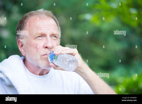 Closeup Portrait Thirsty Senior Mature Man Drinking Water Outside Isolated Green Tree Foliage
